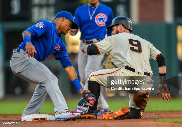 San Francisco Giants First base Brandon Belt is tagged out by Chicago Cubs Shortstop Addison Russell during the MLB game between the Chicago Cubs and...