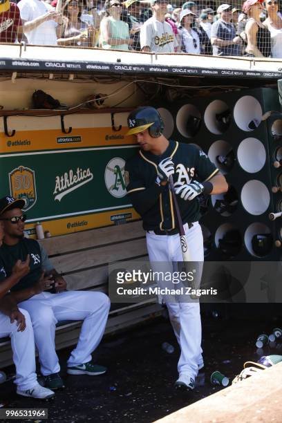 Chad Pinder of the Oakland Athletics stands in the dugout during the game against the Los Angeles Angels of Anaheim at the Oakland Alameda Coliseum...