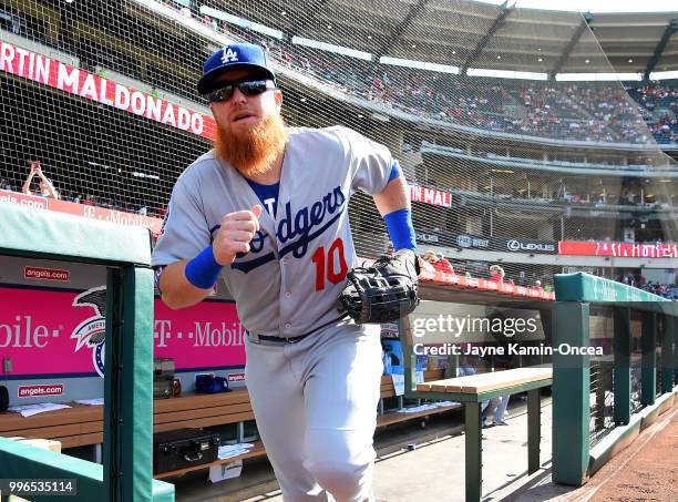 Justin Turner of the Los Angeles Dodgers runs on the field for the first inning of the game against the Los Angeles Angels of Anaheim at Angel...