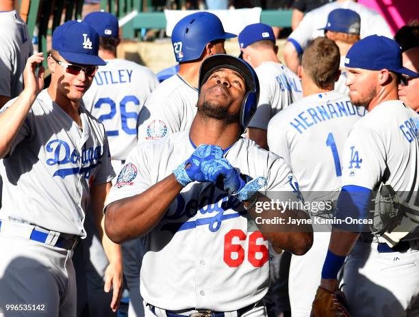 Yasiel Puig of the Los Angeles Dodgers in the dugout after hitting a three run home run in the game against the Los Angeles Angels of Anaheim at...