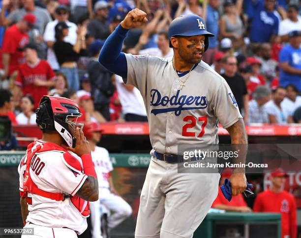 Matt Kemp pumps his fist as he crosses the plate after scoring on a three run home run by Yasiel Puig of the Los Angeles Dodgers in the second inning...