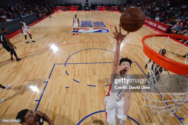 Zhou Qi of the Houston Rockets goes to the basket against the Brooklyn Nets during the 2018 Las Vegas Summer League on July 11, 2018 at the Cox...