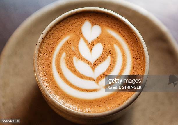 Picture taken on June 8, 2018 shows a prepared cup of coffee at the "Flat White" cafe in the Qatari capital Doha's Tawar Mall. - Tawar Mall looks...