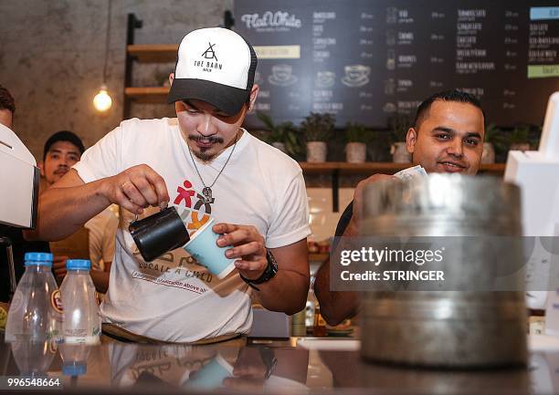 Baristas prepare orders at the "Flat White" cafe in the Qatari capital Doha's Tawar Mall on June 8, 2018. - Tawar Mall looks like any of Qatar's...