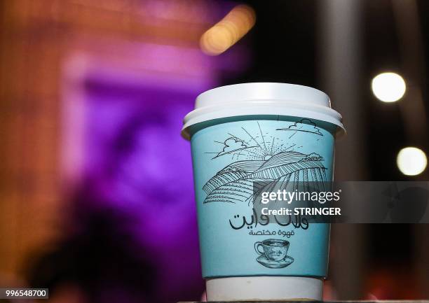 Picture taken on June 8, 2018 shows one of the plastic coffee cups of the "Flat White" cafe in the Qatari capital Doha's Tawar Mall. - Tawar Mall...