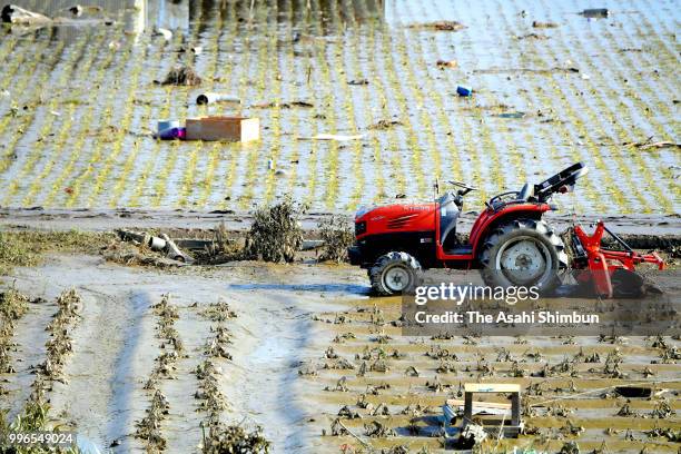 Debris scatters on a rice paddy after floodwater recede on July 11, 2018 in Kurashiki, Okayama, Japan. The death toll from the torrential rain in...