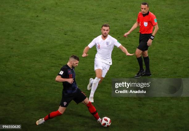 Ante Rebic of Croatia in action against Jordan Henderson of England during the 2018 FIFA World Cup Russia Semi Final match between England and...