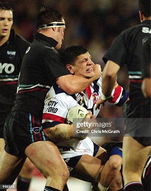 Michael Korkidas for the Sydney Roosters is tackled by Craig Greenhill for Penrith during the round 20 NRL match played between the Penrith Panthers...