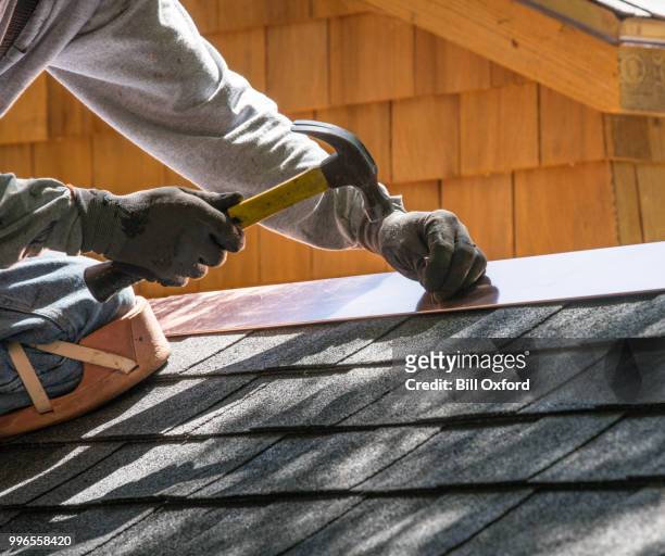 repairing roof. nailing flashing - roofing contractor stock pictures, royalty-free photos & images