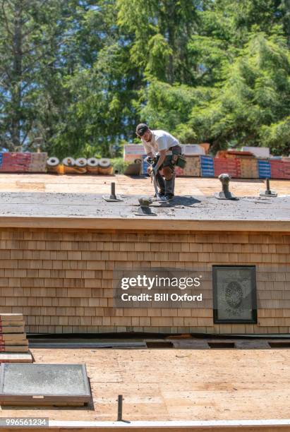 installing new tile roof. removing tiles. - bill oxford stock pictures, royalty-free photos & images