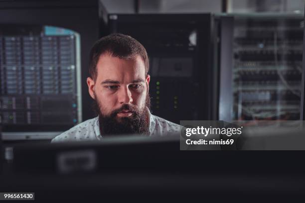 young it engineer inspecting data center servers - computer hardware engineer stock pictures, royalty-free photos & images
