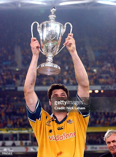 John Eales of the Wallabies holds the Tri Nations trophy aloft after victory in the Tri Nations rugby union match between the Australian Wallabies...