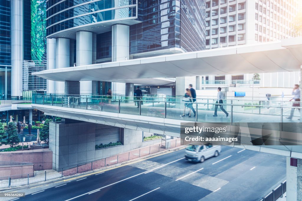 Side view of commuters walking through covered footbridge