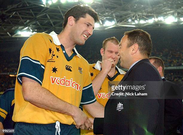 John Eales of the Wallabies and coach Eddie Jones celebrate victory in the Tri Nations rugby union match between the Australian Wallabies and the New...