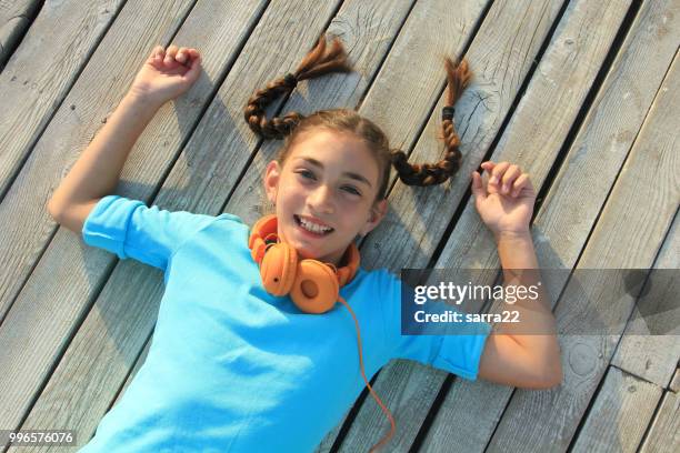 little girl lying on the ground - girl with orange hair stock pictures, royalty-free photos & images