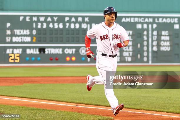 Steve Pearce of the Boston Red Sox rounds the bases after hitting a two-run home run in the first inning of a game against the Texas Rangers at...