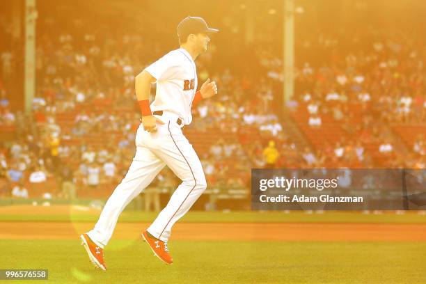 Andrew Benintendi of the Boston Red Sox warms up before a game against the Texas Rangers at Fenway Park on JULY 9, 2018 in Boston, Massachusetts.