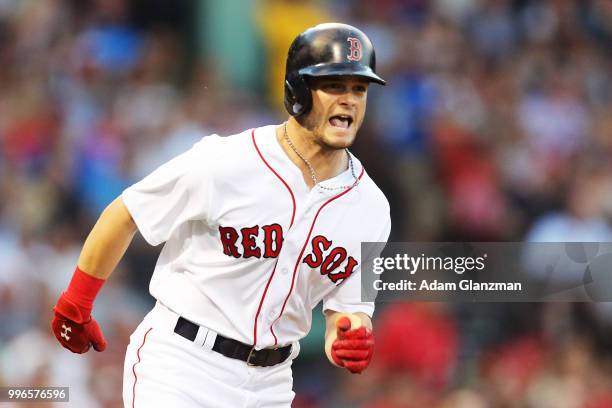 Andrew Benintendi of the Boston Red Sox runs to first base during a game against the Texas Rangers at Fenway Park on JULY 9, 2018 in Boston,...