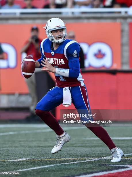 Quarterback Jeff Mathews of the Montreal Alouettes looks to play the ball against the Ottawa Redblacks during the CFL game at Percival Molson Stadium...
