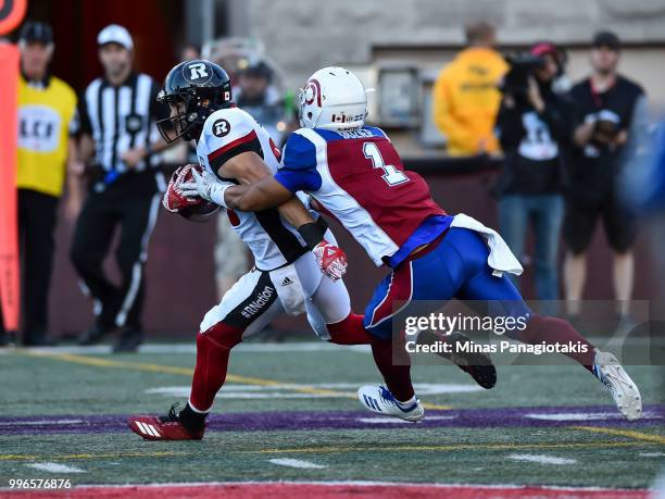 Defensive back Branden Dozier of the Montreal Alouettes tries to grab a hold of wide receiver Brad Sinopoli of the Ottawa Redblacks during the CFL...