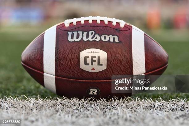 An official football sits on the field during the CFL game between the Montreal Alouettes and the Ottawa Redblacks at Percival Molson Stadium on July...