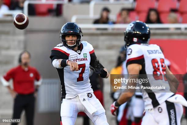 Quarterback Trevor Harris of the Ottawa Redblacks throws the ball against the Montreal Alouettes during the CFL game at Percival Molson Stadium on...