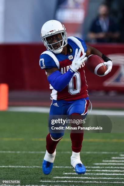 Running back Stefan Logan of the Montreal Alouettes runs with the ball against the Ottawa Redblacks during the CFL game at Percival Molson Stadium on...