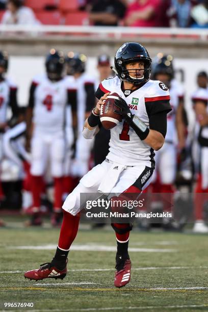 Quarterback Trevor Harris of the Ottawa Redblacks looks to play the ball against the Montreal Alouettes during the CFL game at Percival Molson...
