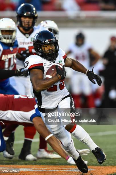 Running back William Powell of the Ottawa Redblacks runs with the ball against the Montreal Alouettes during the CFL game at Percival Molson Stadium...