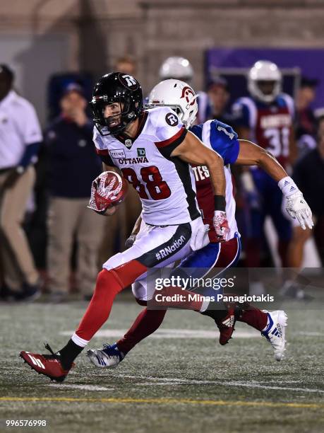 Wide receiver Brad Sinopoli of the Ottawa Redblacks runs with the ball against defensive back Branden Dozier of the Montreal Alouettes during the CFL...