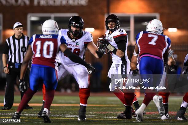 Quarterback Trevor Harris of the Ottawa Redblacks looks to play the ball against the Montreal Alouettes during the CFL game at Percival Molson...