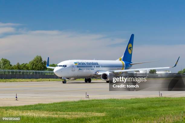ukraine international airlines jet taxiing to take off at the boryspil airport, ukraine - ukraine international airlines stock pictures, royalty-free photos & images