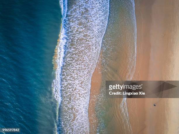 aerial view of coastline with beach and ocean waves, taken by drone - sanya stock pictures, royalty-free photos & images
