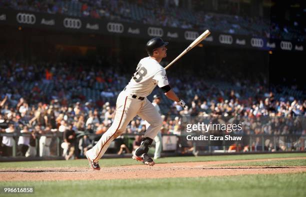 Buster Posey of the San Francisco Giants hits the game winning hit in the bottom of the 13th inning to beat the Chicago Cubs at AT&T Park on July 11,...