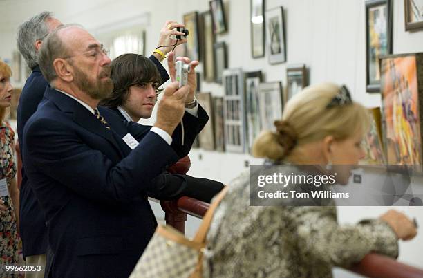 Andres Zighelboim of Florida, views his piece as his grandfather, Elias Zisman, takes a picture at the opening of the 2009 Congressional Art...