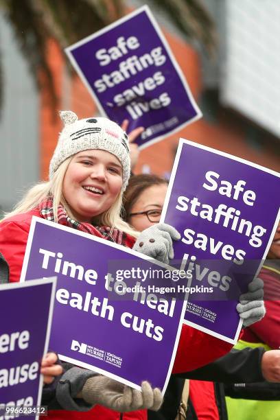 Nurses and Workers Union members hold signs during a strike at Wellington Regional Hospital on July 12, 2018 in Wellington, New Zealand. Thousands of...