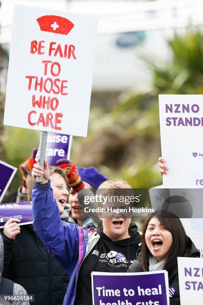 Nurses and Workers Union members hold signs during a strike at Wellington Regional Hospital on July 12, 2018 in Wellington, New Zealand. Thousands of...