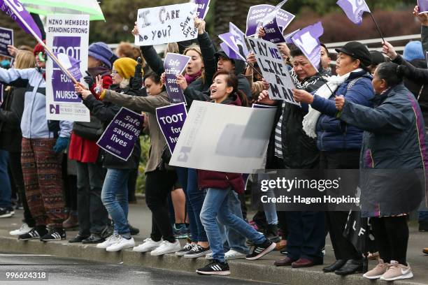 Nurses and Workers Union members hold signs during a strike at Wellington Regional Hospital on July 12, 2018 in Wellington, New Zealand. Thousands of...