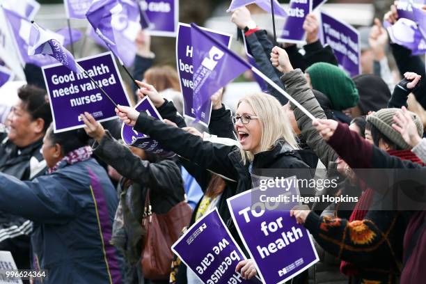 Nurses and Workers Union members hold signs during a strike at Wellington Regional Hospital on July 12, 2018 in Wellington, New Zealand. Thousands of...