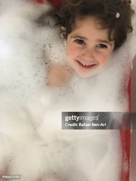 young girl having a bubble bath - rafael ben ari stock pictures, royalty-free photos & images