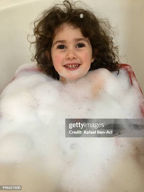 young girl having a bubble bath - rafael ben ari fotografías e imágenes de stock