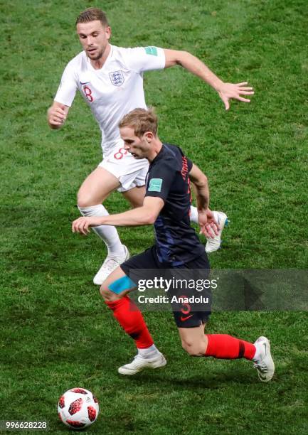 Ivan Strinic of Croatia in action against Jordan Henderson of England during the 2018 FIFA World Cup Russia Semi Final match between England and...