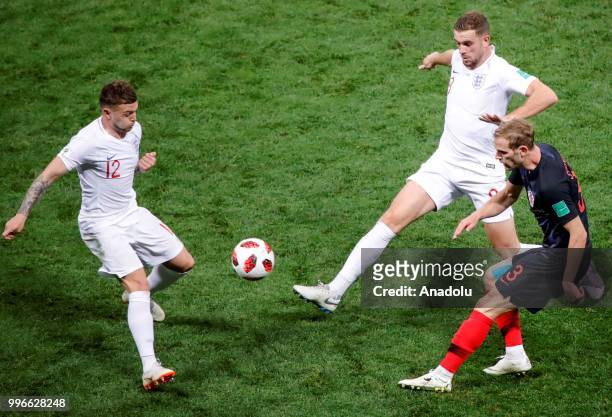 Ivan Strinic of Croatia in action against Jordan Henderson and Kieran Trippier of England during the 2018 FIFA World Cup Russia Semi Final match...
