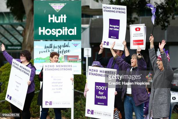 Nurses and Workers Union members hold signs during a strike at Hutt Hospital on July 12, 2018 in Lower Hutt, New Zealand. Thousands of nurses voted...