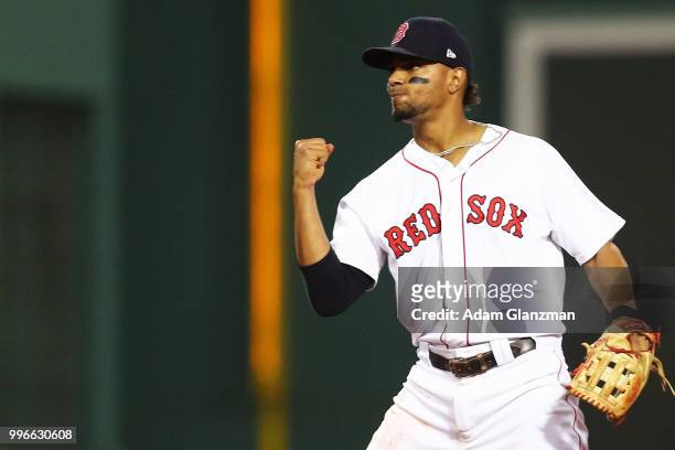 Xander Bogaerts of the Boston Red Sox reacts after Turing a double play in the sixth inning of a game against the Texas Rangers at Fenway Park on...