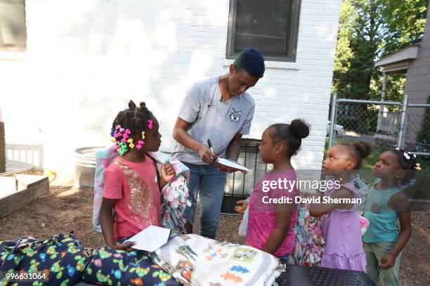 Danielle Robinson of the Minnesota Lynx delivers tie blankets made by Lynx players and staff to family participants of Simpson Housing Services, a...