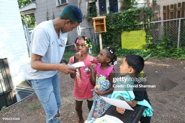 Danielle Robinson of the Minnesota Lynx delivers tie blankets made by Lynx players and staff to family participants of Simpson Housing Services, a...