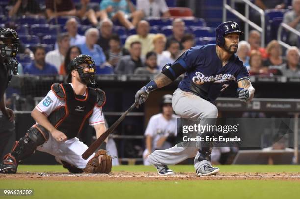 Eric Thames of the Milwaukee Brewers hits a double in the third inning against the Miami Marlins at Marlins Park on July 11, 2018 in Miami, Florida.