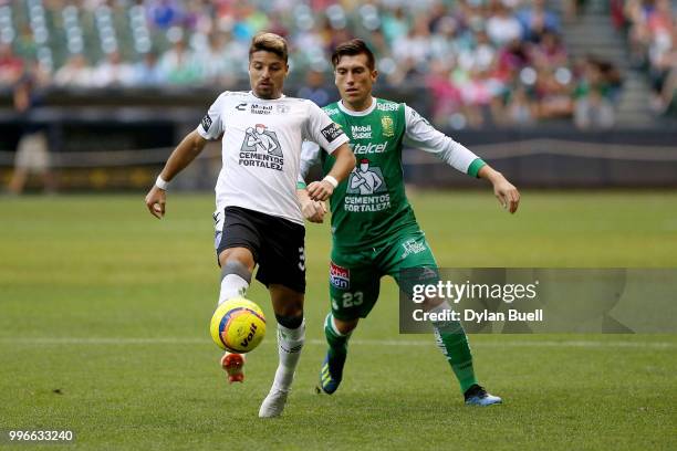 Sebastian Palacios of CF Pachuca dribbles the ball while being pressured by Juan Cornejo of Club Leon in the first half at Miller Park on July 11,...