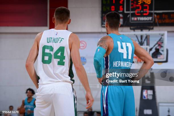 Jarrod Uthoff of the Boston Celtics and Willy Hernangomez of the Charlotte Hornets look on during the game during the 2018 Las Vegas Summer League on...